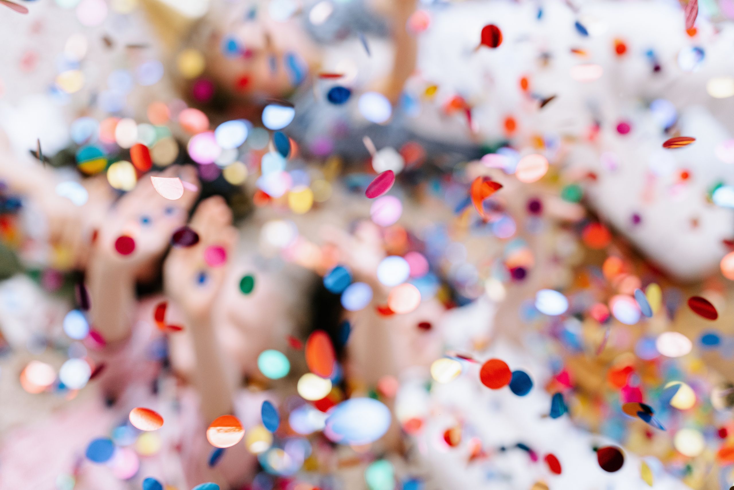Vibrant confetti shower creating a joyful atmosphere at a lively party celebration.